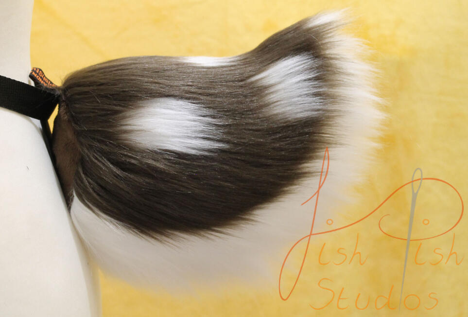 A brown topped nub deer like tail with white spots and a white underside. Made with luxury faux fur for fursuits, larp and therian costumes
