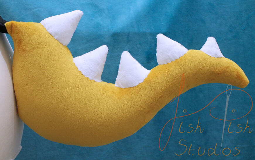 A gold and white spiked dinosaur tail used mostly for bowsette type cosplays. Made from minky fabric by fishpish studios