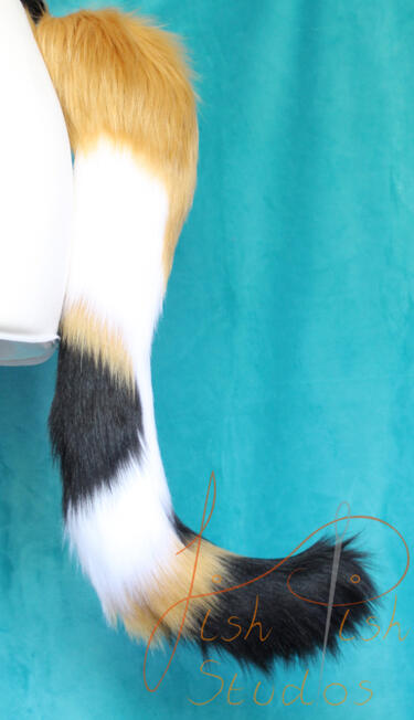 A caramel, white and black calico cat styled tail for therians, furries and cosplays. approx 17 inches long, this is handmade with luxury faux fur in the UK by fishpish studios