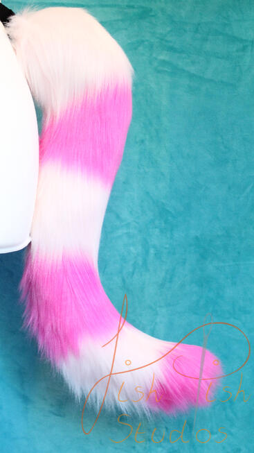 Striped Cheshire Cat Tail A bright and pale pink alternating striped cat tail. Approx 17 inches long, this is great for furries, therians and cosplays. Design is based on the famous Cheshire Cat, but colours can be changed to suit. handmade in the UK by fishpish studios