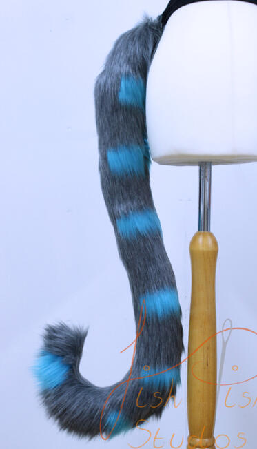 Blue and Grey Striped Cat Tail a custom made luxury faux fur blue and grey striped cat fursuit tail. one of the first ones made, this one consists of 7 hand sewn stripes. it attaches to a belt using belt loops. handmade by fishpish studios
