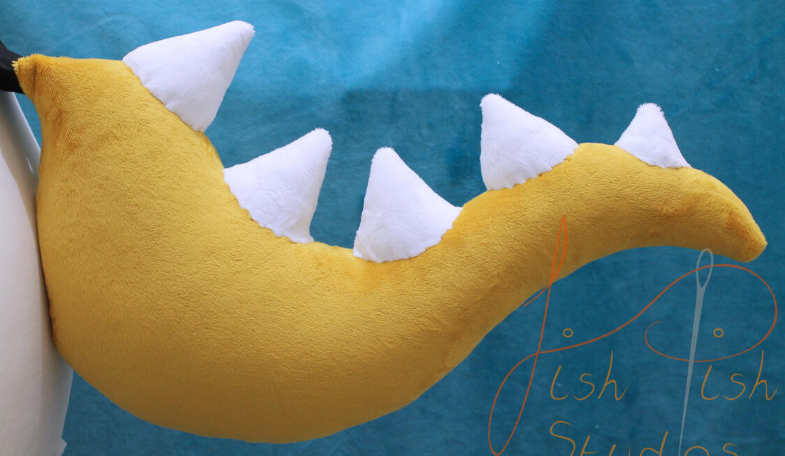 Bowsette Tail A great cosplay addition for any bowsette costume. Made of soft plush, this tail is about 21 inches long, and attaches with belt loops. As it is made of fabric, it can also be altered to be permanatly attached to any clothing. Handmade by fishpishstudios