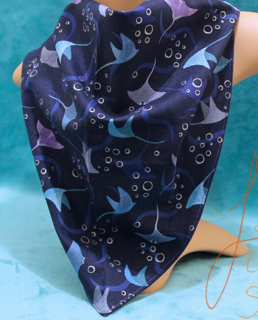 a deep blue watery bandana with mantarays and bubbles on it. it handmade and larger than usual for fursuiters and fashion statements