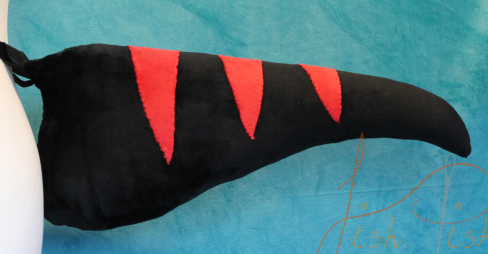 Red and Black Striped Raptor Tail Inspired by the velociraptors in jurassic park, this striped raptor tail is one of the original designs made by fishpish studios. Made with soft plush (minky) fabric, the stripes are hand sewn on. Available in store