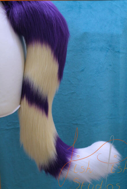A commissioned piece, this fantasy cat tail is made with cream, purple and white luxury faux. is attaches with a belt, and is made for therian cosplay by fishpish studios