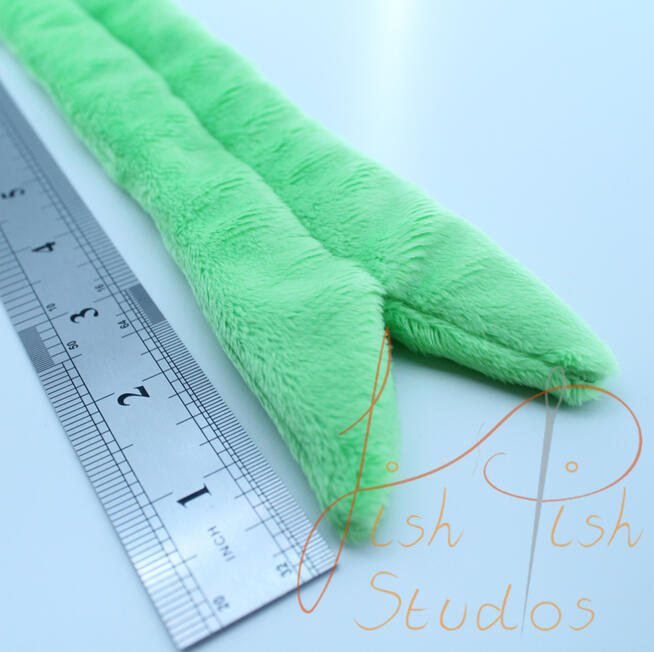 A close up image of a fursuit tongue made by fishpish studios. this tongue is about 5 inches long in the forked style. its made with soft plush fabric and is ideal for fursuit heads