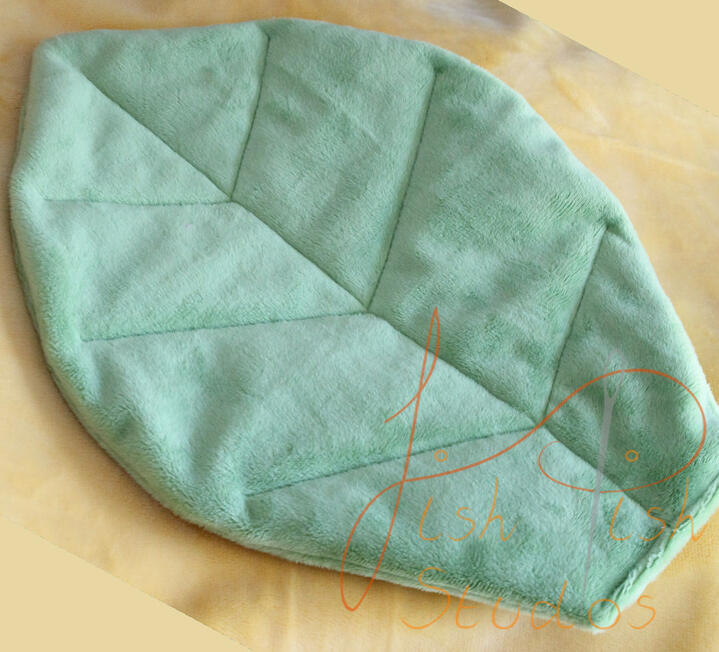 A close up shot of a custom plush leaf prop for cosplays, plushies and fursuits. Made of soft plush fabric, this drapes beautifully over an item. Available in a varity of colours from fishpish studios