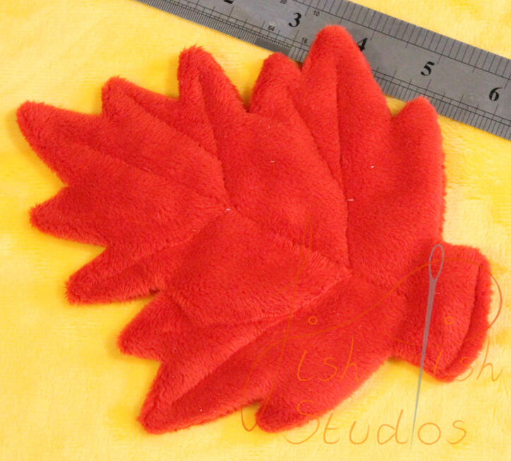 A close up shot of a custom plush leaf prop for cosplays, plushies and fursuits. Made of soft plush fabric, this drapes beautifully over an item. Available in a varity of colours from fishpish studios