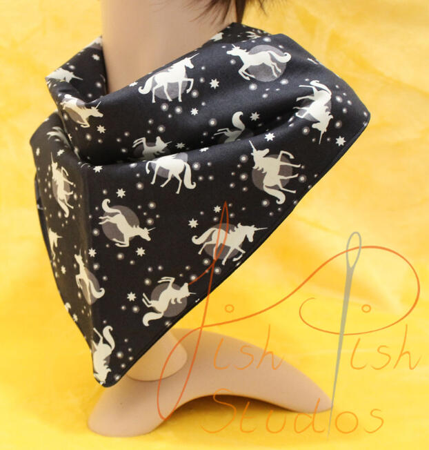 an XL bandana with little glowing unicorn on a black background. The fabrics are polycotton. The design is XL at 36 inches, making it a great fashion accessory or something to decorate your fursuit. handmade in the UK by fishpish studios